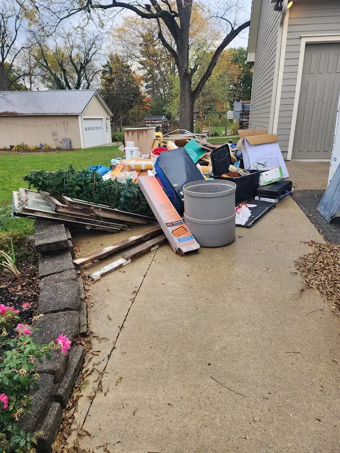 Dumpster being loaded with debris for 30 Yard Dumpster Rental in Crete